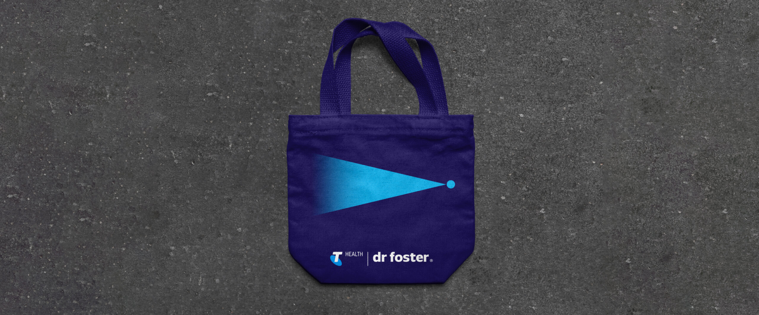 Mockups of a tote bag showcasing the brand