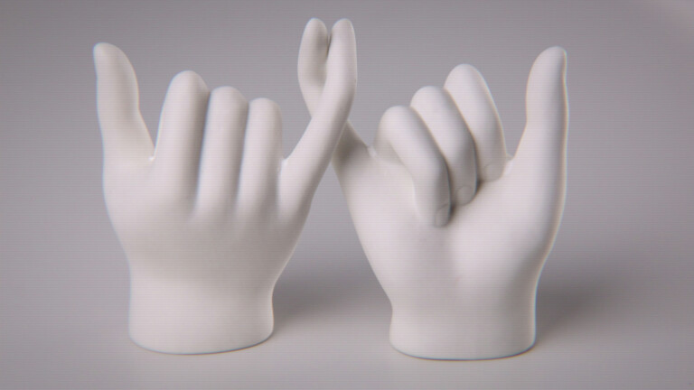 two hands with interlocking pinky fingers