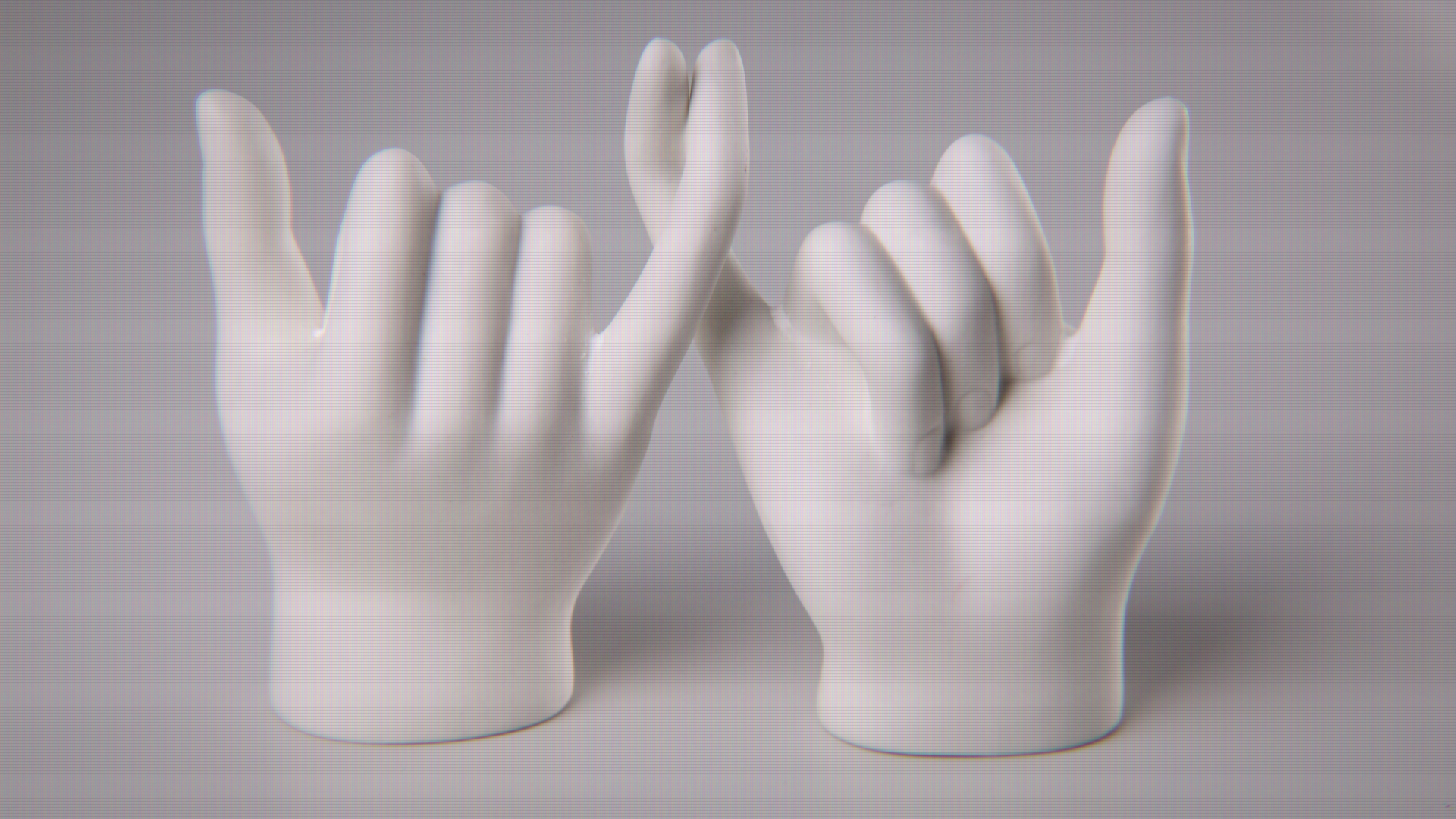 two hands with interlocking pinky fingers